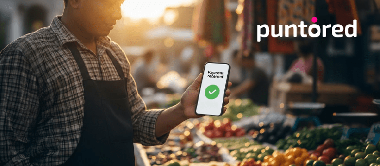 Digital financial inclusion in action as a small merchant receives a successful digital payment using a mobile device.